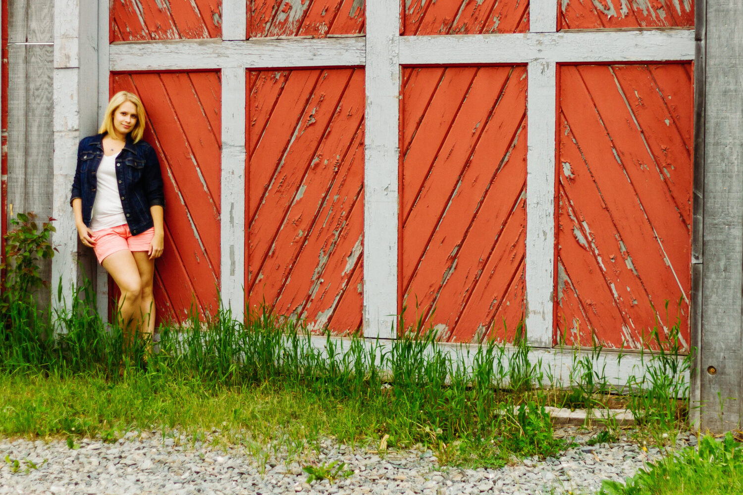 Woman standing in front of a barn in Belfast Maine