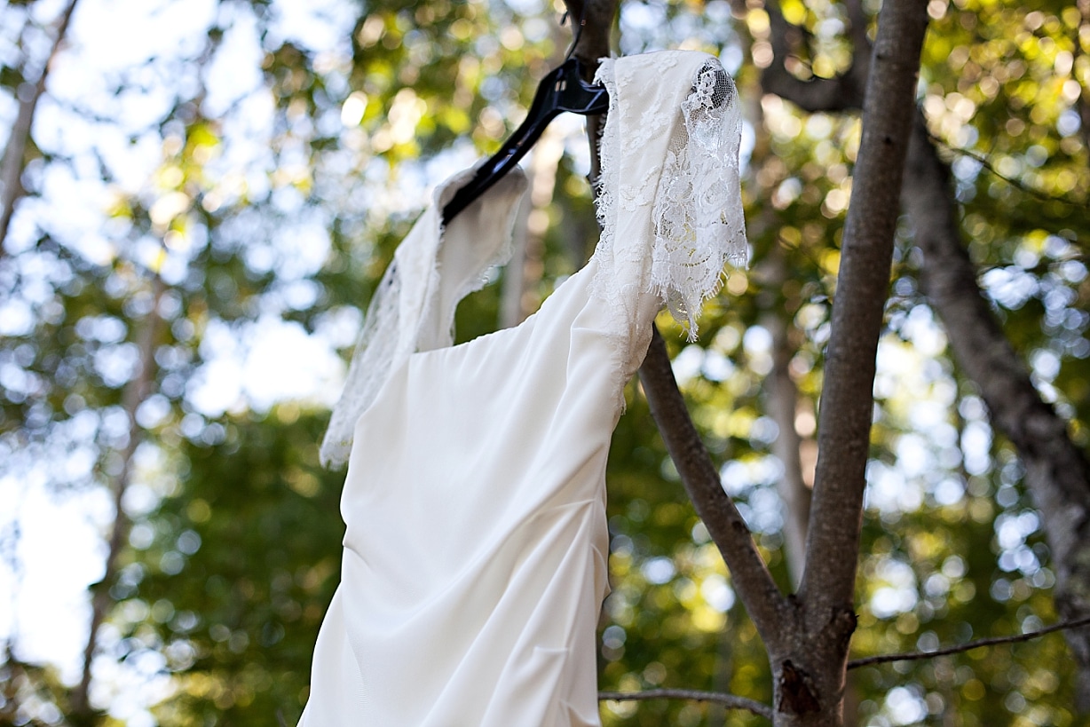 Bride's wedding dress hanging from a tree at the Inn at Ocean's Edge in Lincolnville, Maine