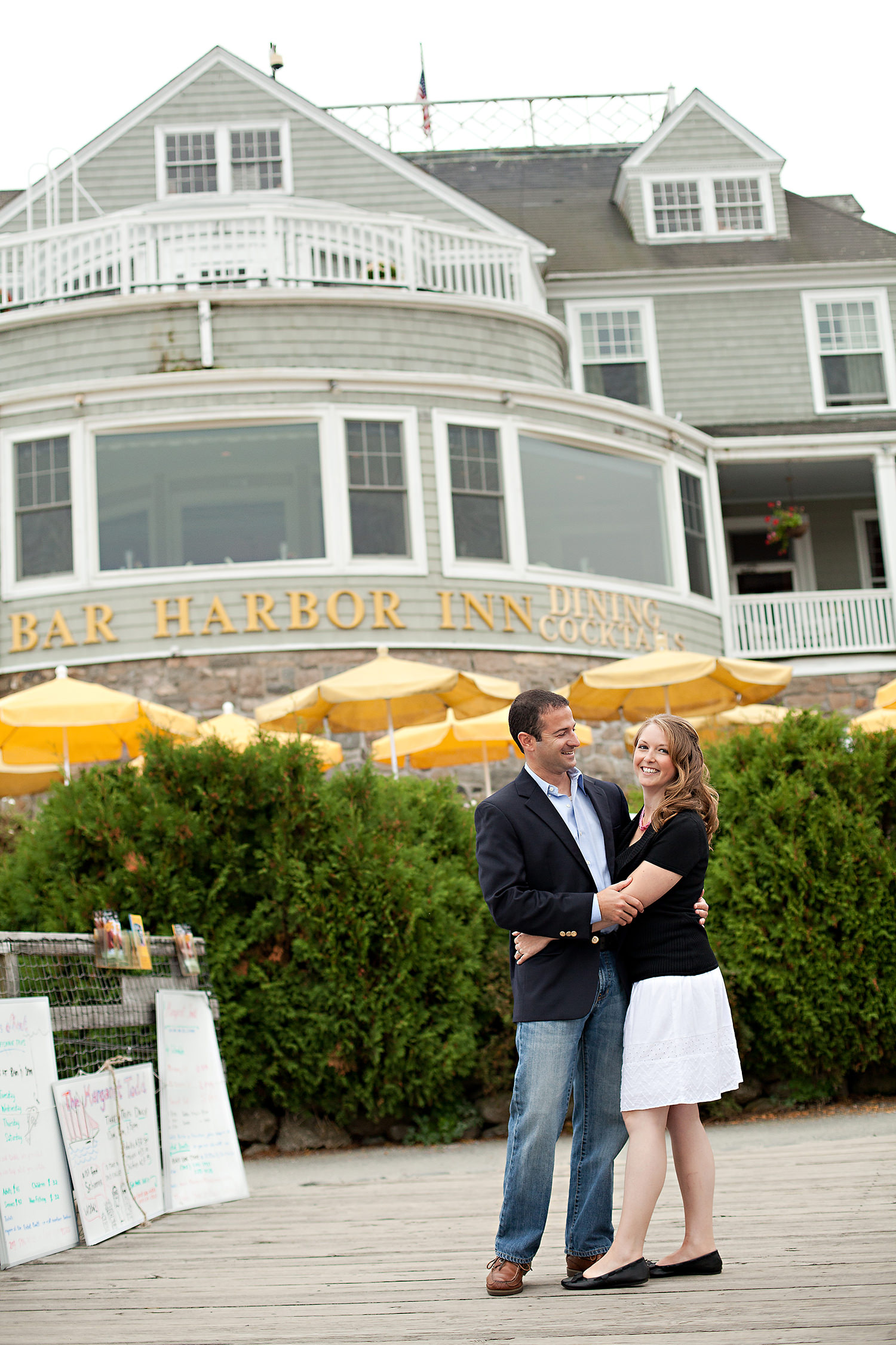 couple standing in front of the Bar Harbor Inn during engagement photos in Bar Harbor