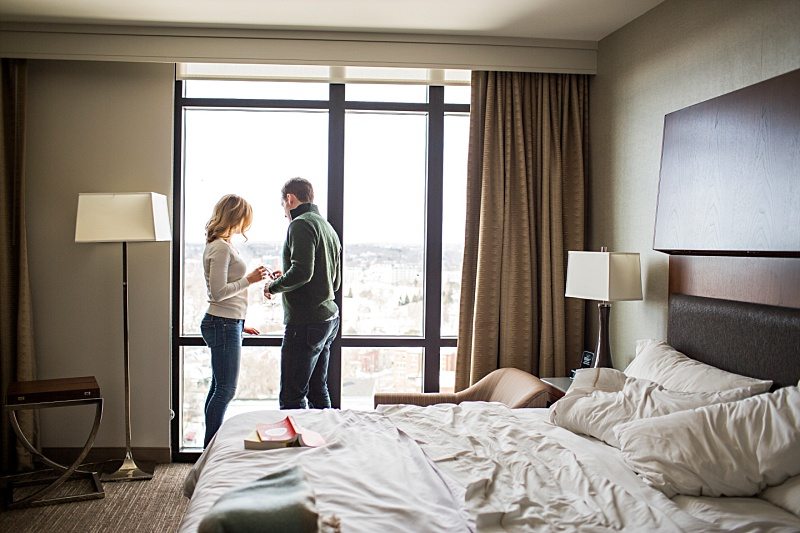 couple standing in hotel room window