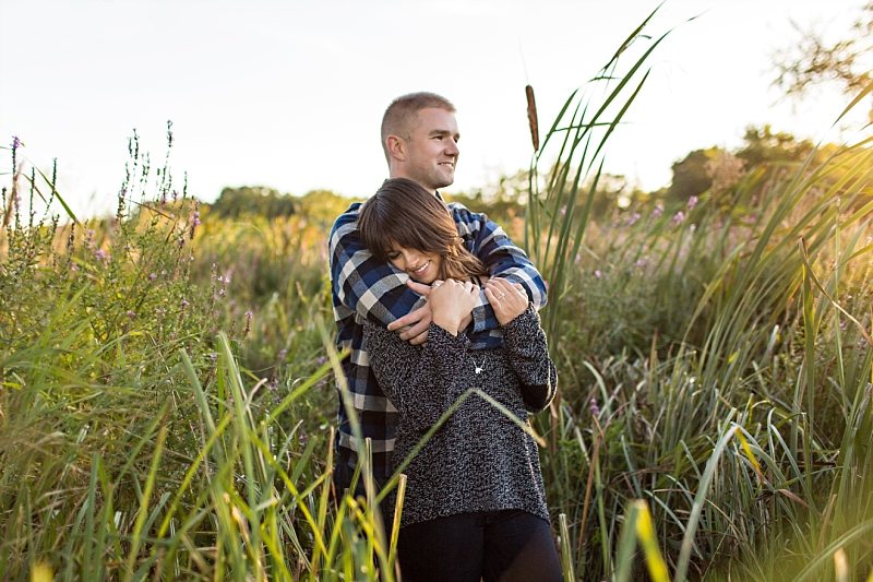A man holds his fiancee in his arms in Newburyport, Massachusetts.