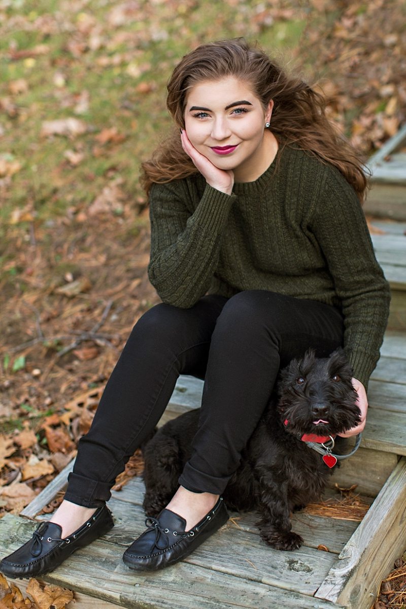 A senior poses with her Scottie dog.