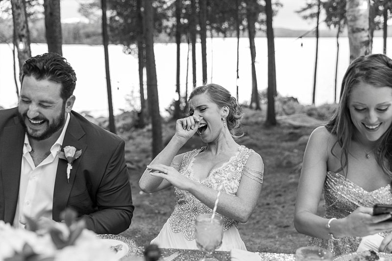 The bride, groom, and maid of honor laugh heartily after the best man drops his pants during his wedding toast.