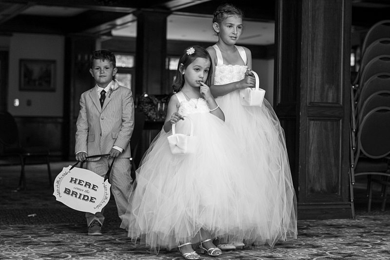 The flower girls and ring bearer wait patiently for their entrance into the ceremony.