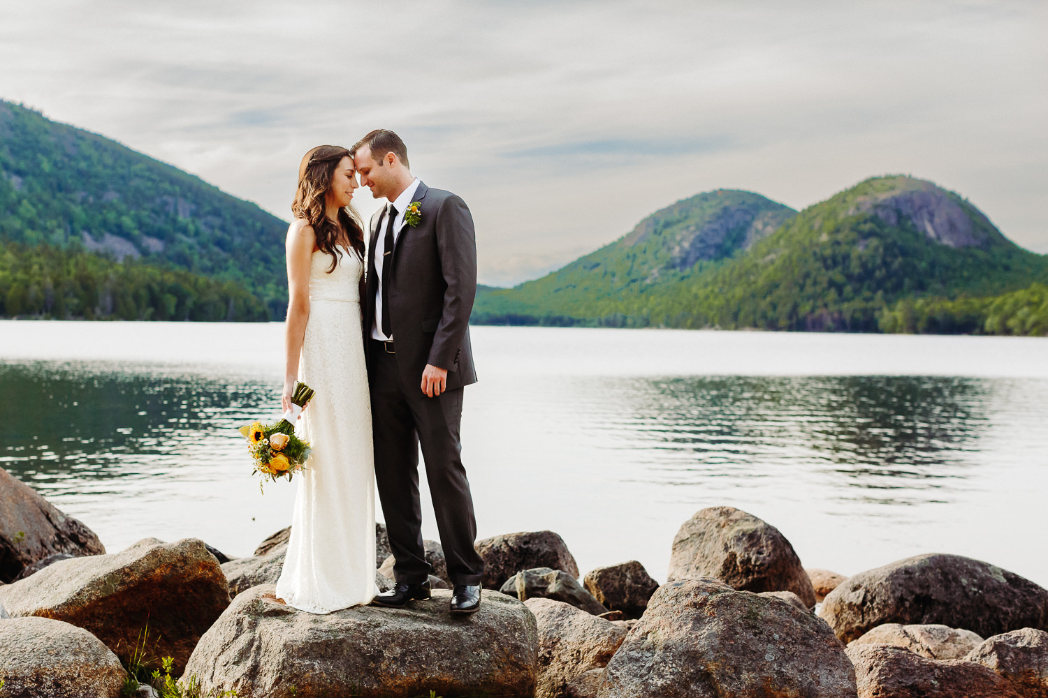 Bride and groom standing in front of The Bubbles at Acadia National Park elopement