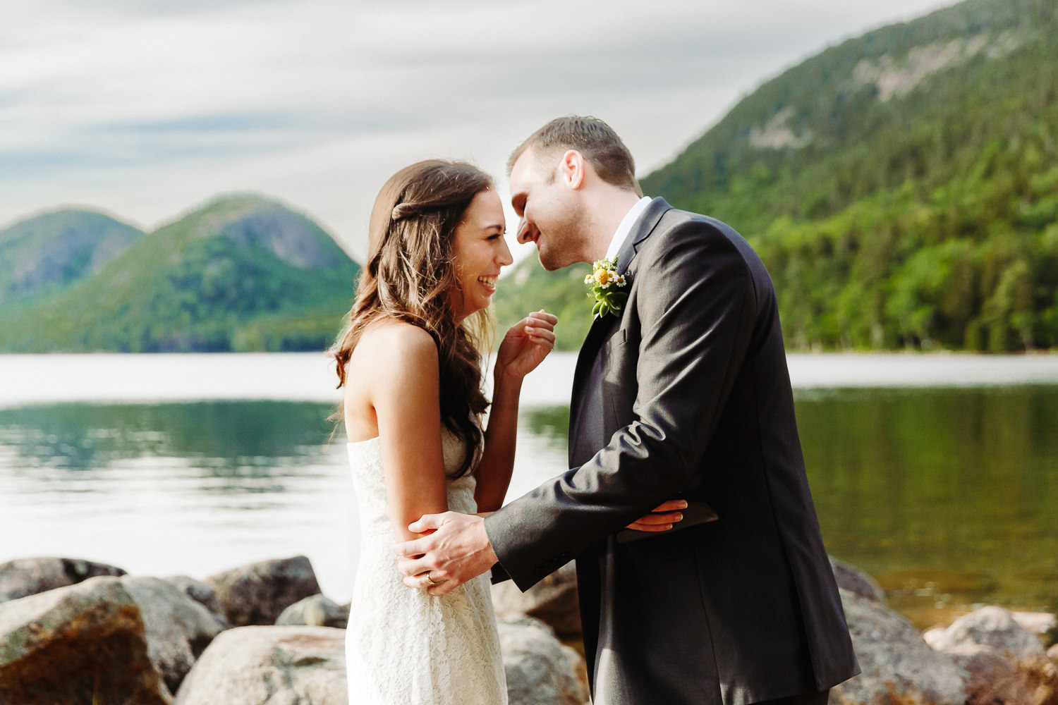 Bride laughs after Bride and groom pose for a wedding portrait at Jordan Pond in Acadia National Park.