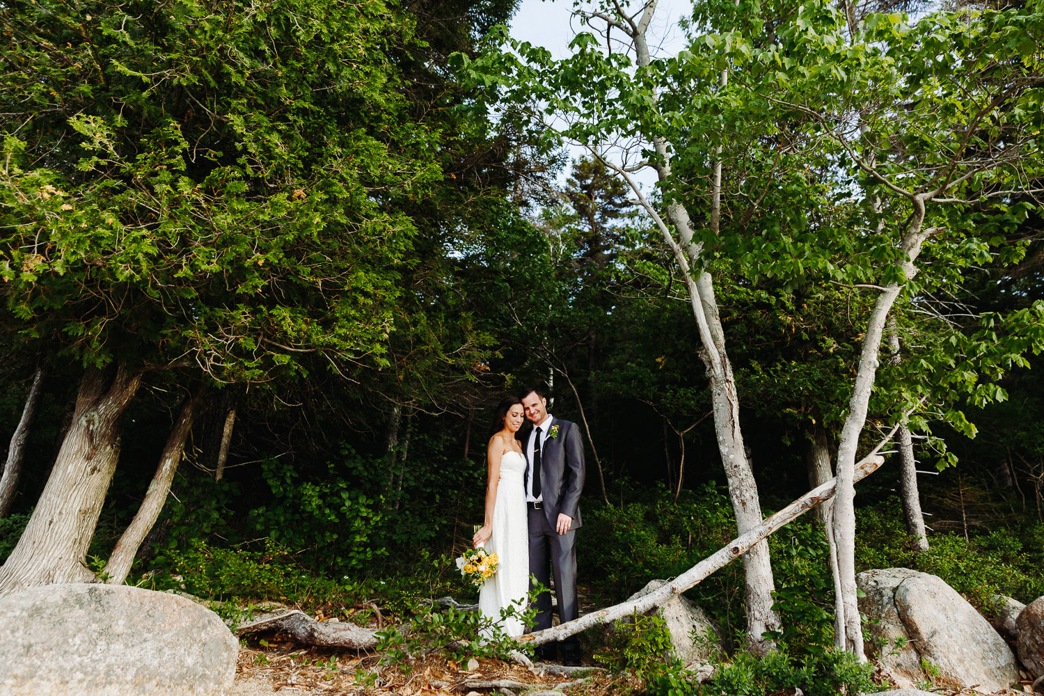 Bride and groom standing in the woods during elopement at Jordan Pond in Acadia National Park.