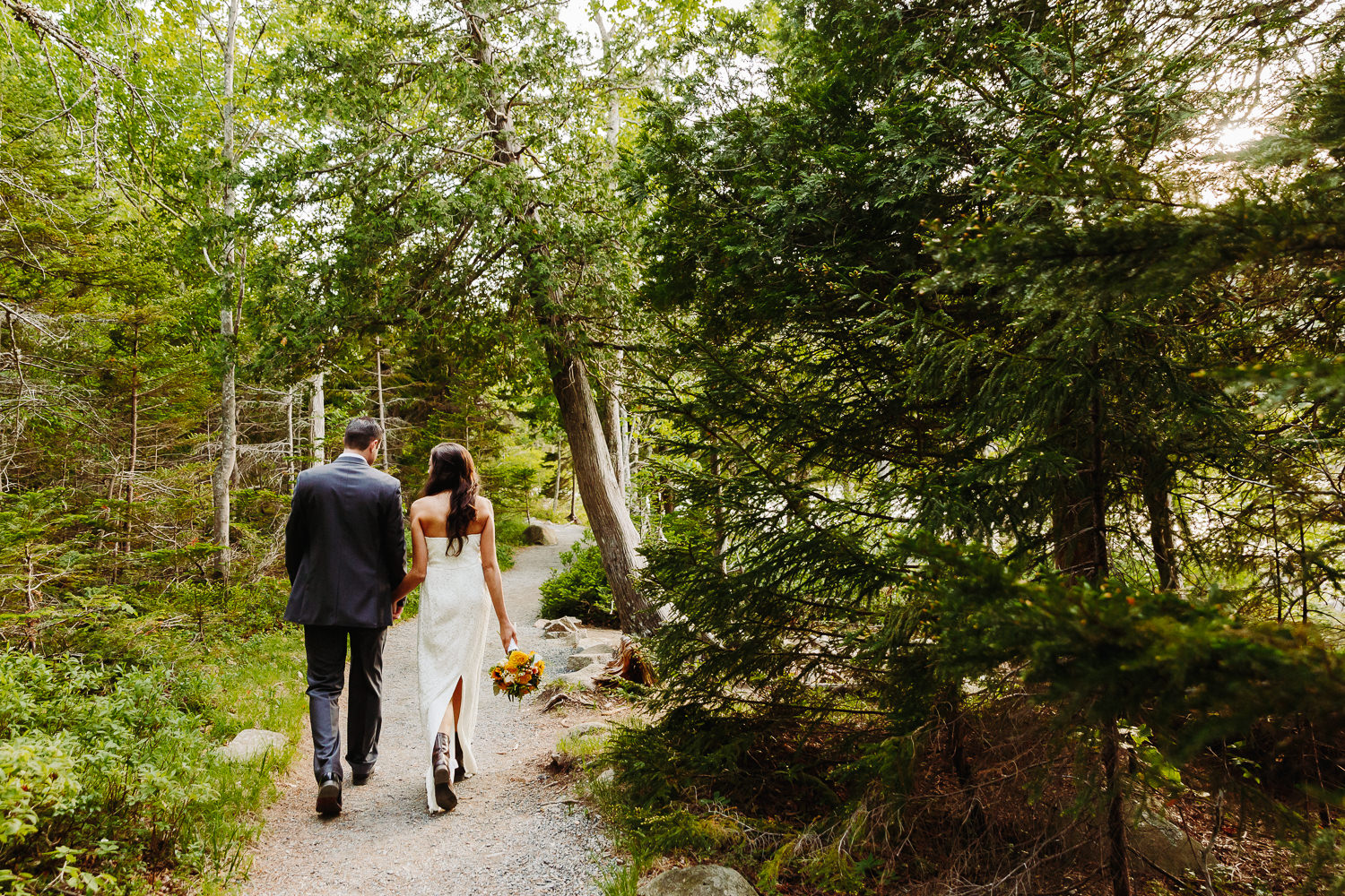 Bride and groom walking together after elopement at Jordan Pond in Acadia National Park