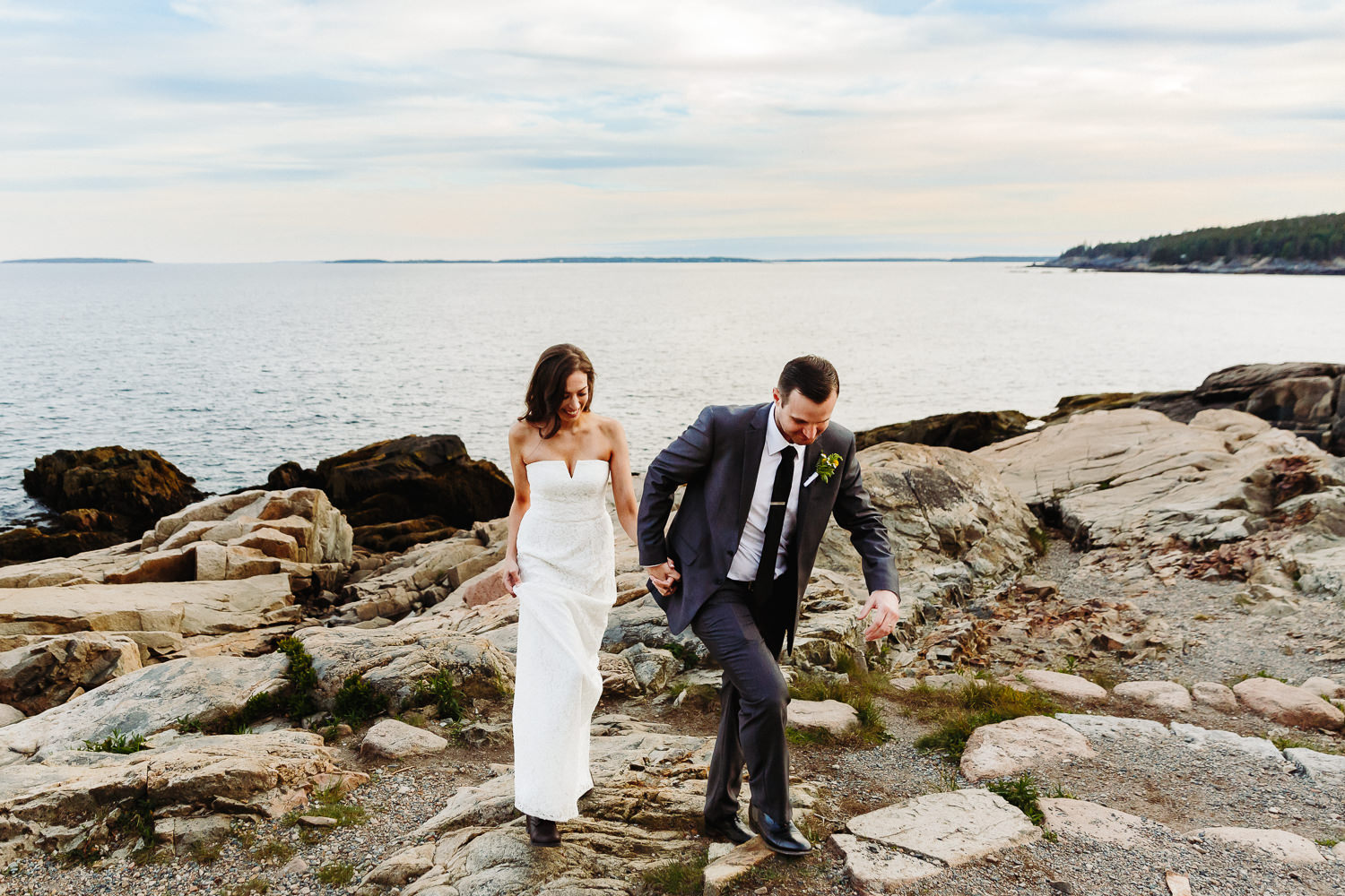 Bride and groom walking at Otter Point
