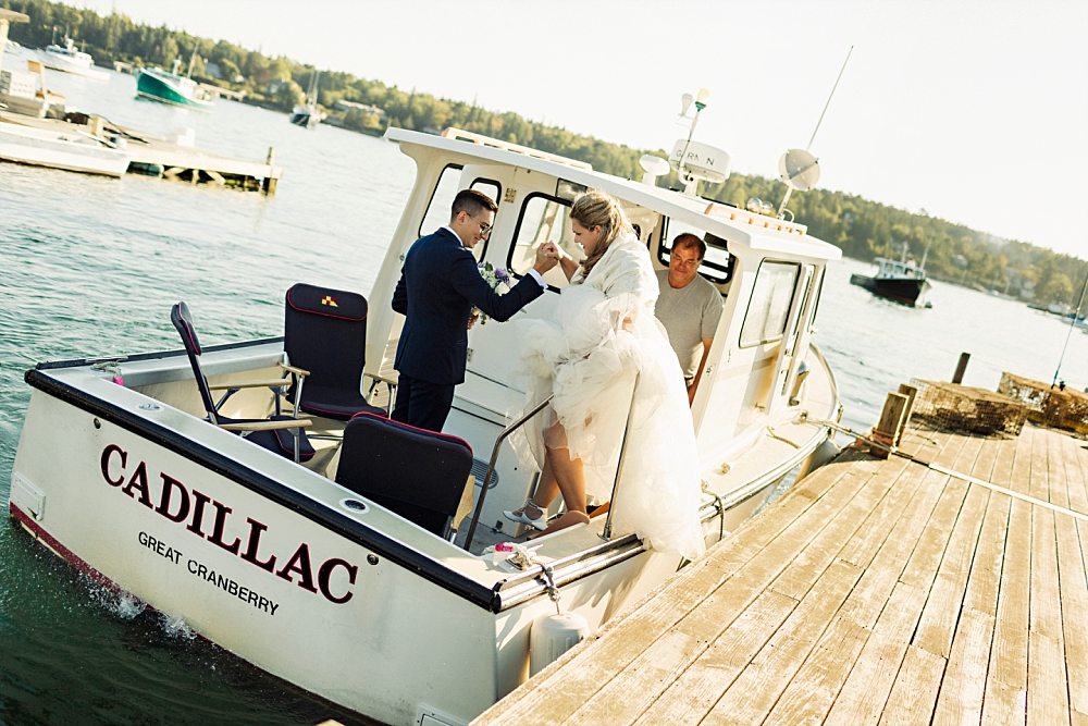 Bride and groom boarding boat to Claremont Hotel Southwest Harbor wedding