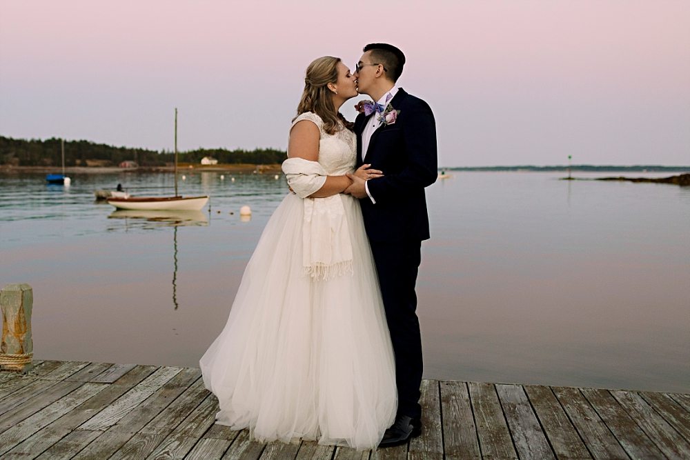 couple kissing on dock at sunset at Claremont Hotel Southwest Harbor wedding