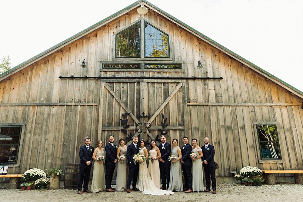 wedding party in front of barn during wedding at Granite Ridge Estate & Barn