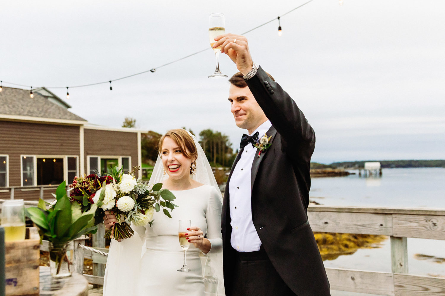 Bride and groom toast guests at Maine wedding at The Contented Sole