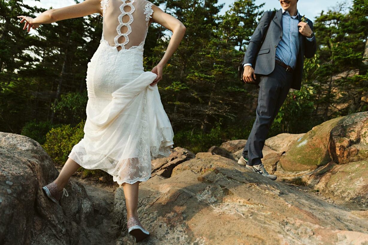 Bride and groom hiking after Acadia National Park elopement