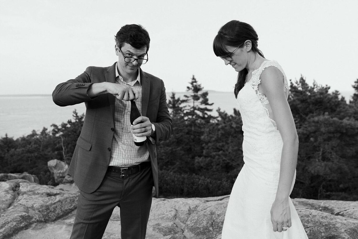 Bride and groom opening a beer after Acadia elopement