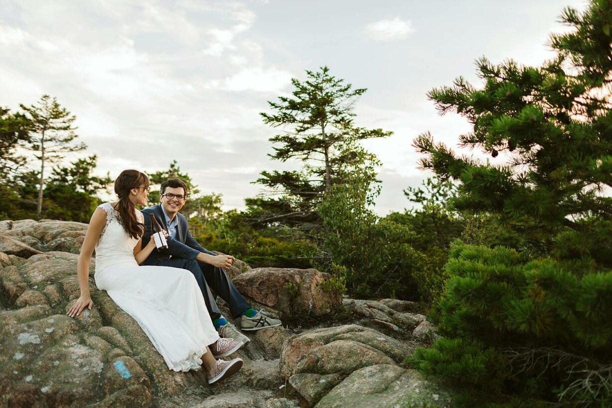 bride and groom share a beer after hiking in Acadia National Park