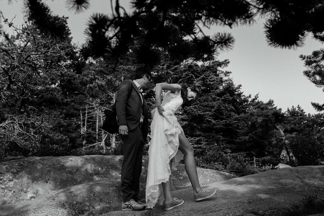 Bride pulls up her dress to hike in Acadia National Park