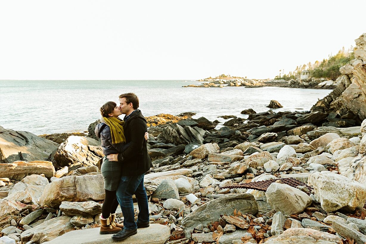 Couple kissing on rocky beach