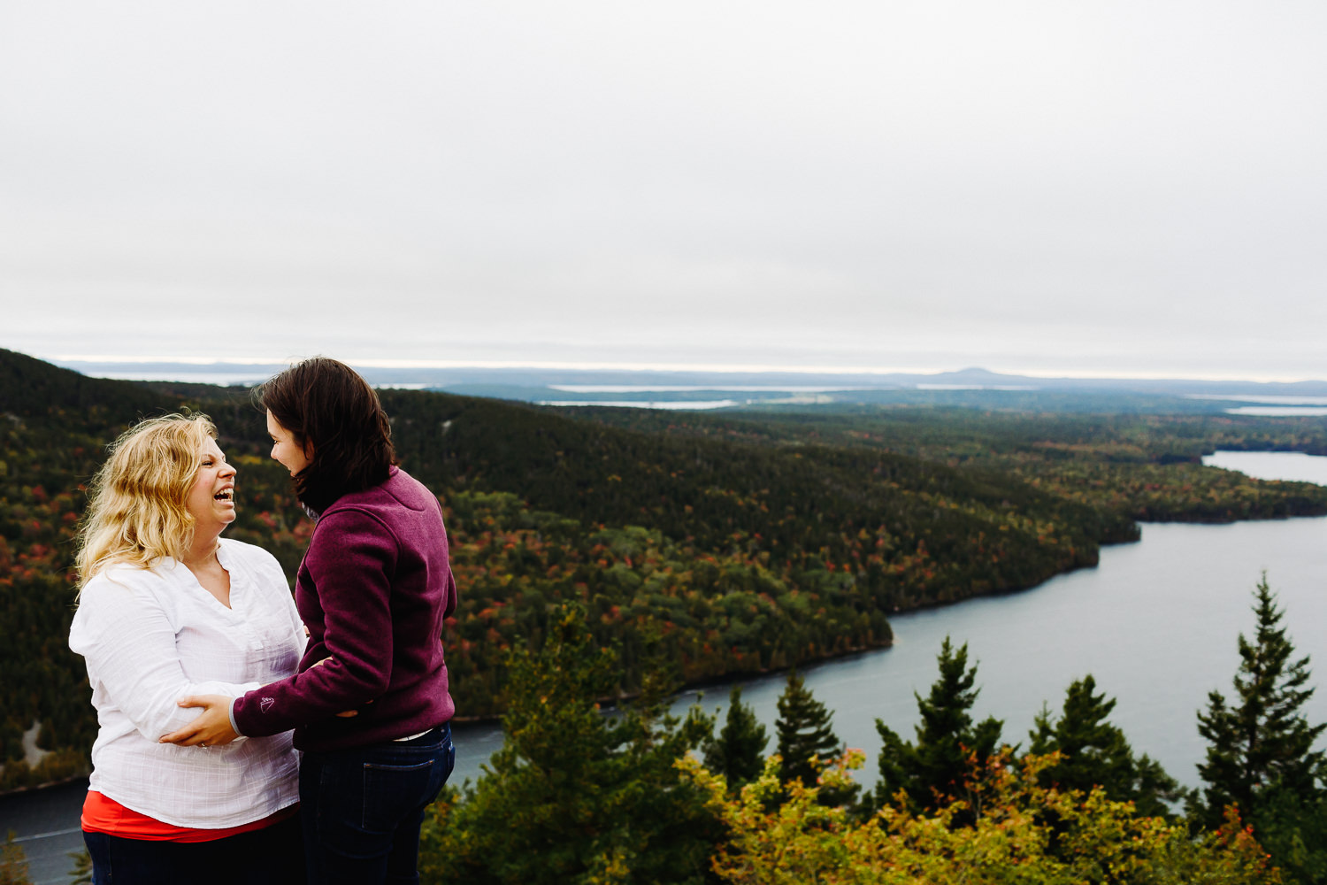 Two women who just got engaged on Beech Mountain in Acadia National Park