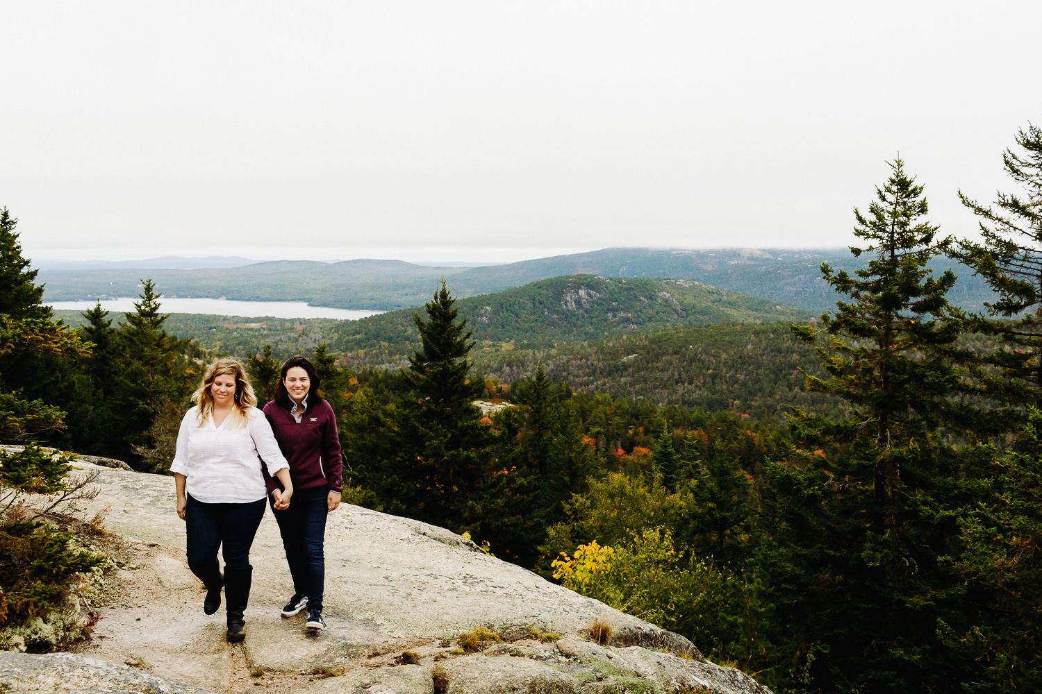women hold hands and laugh on Beech Mountain on MDI