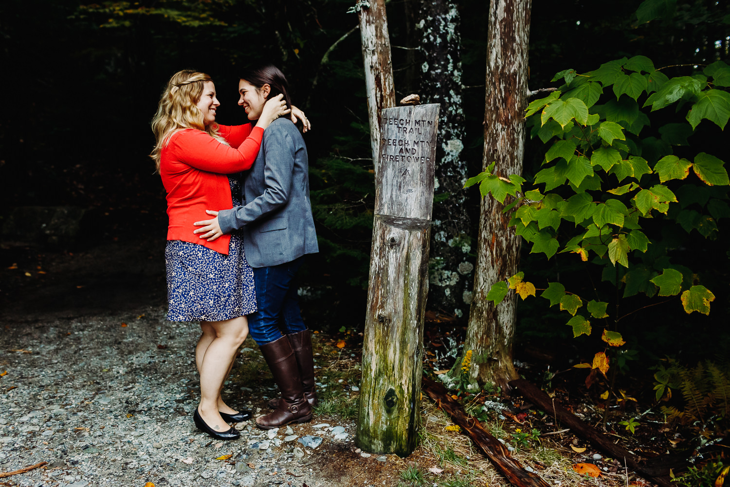 two women hugging and smiling at each other next to Beech Mountain trailhead on MDI