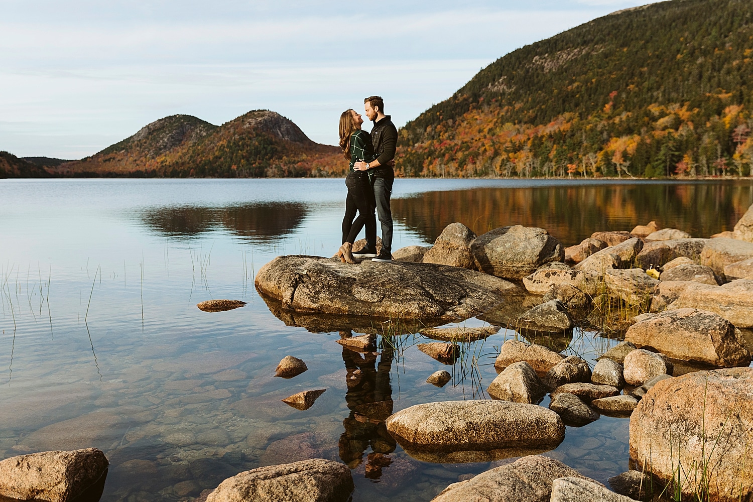 couple standing on rocks in Jordan Pond