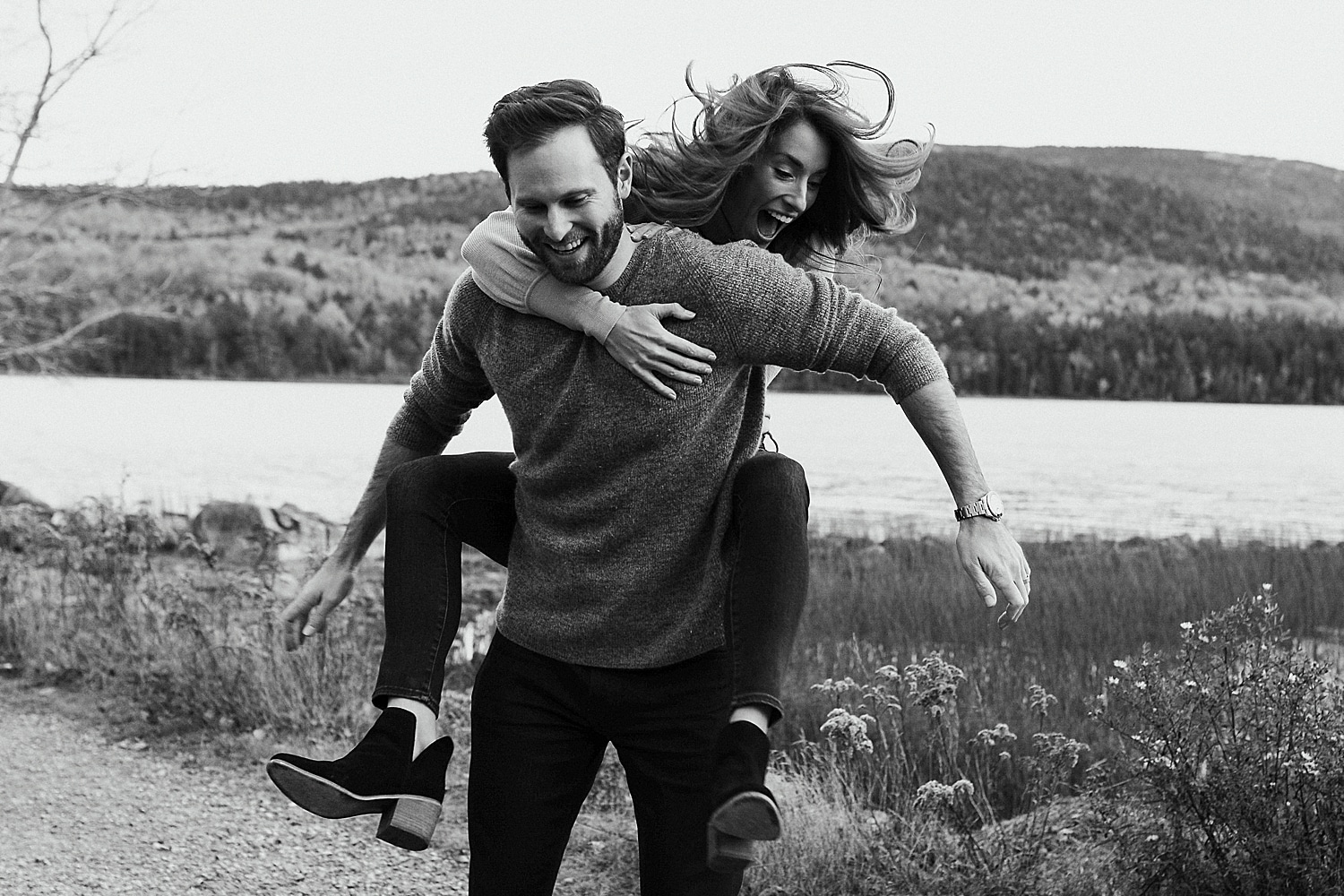 woman jumping on man's back for piggyback