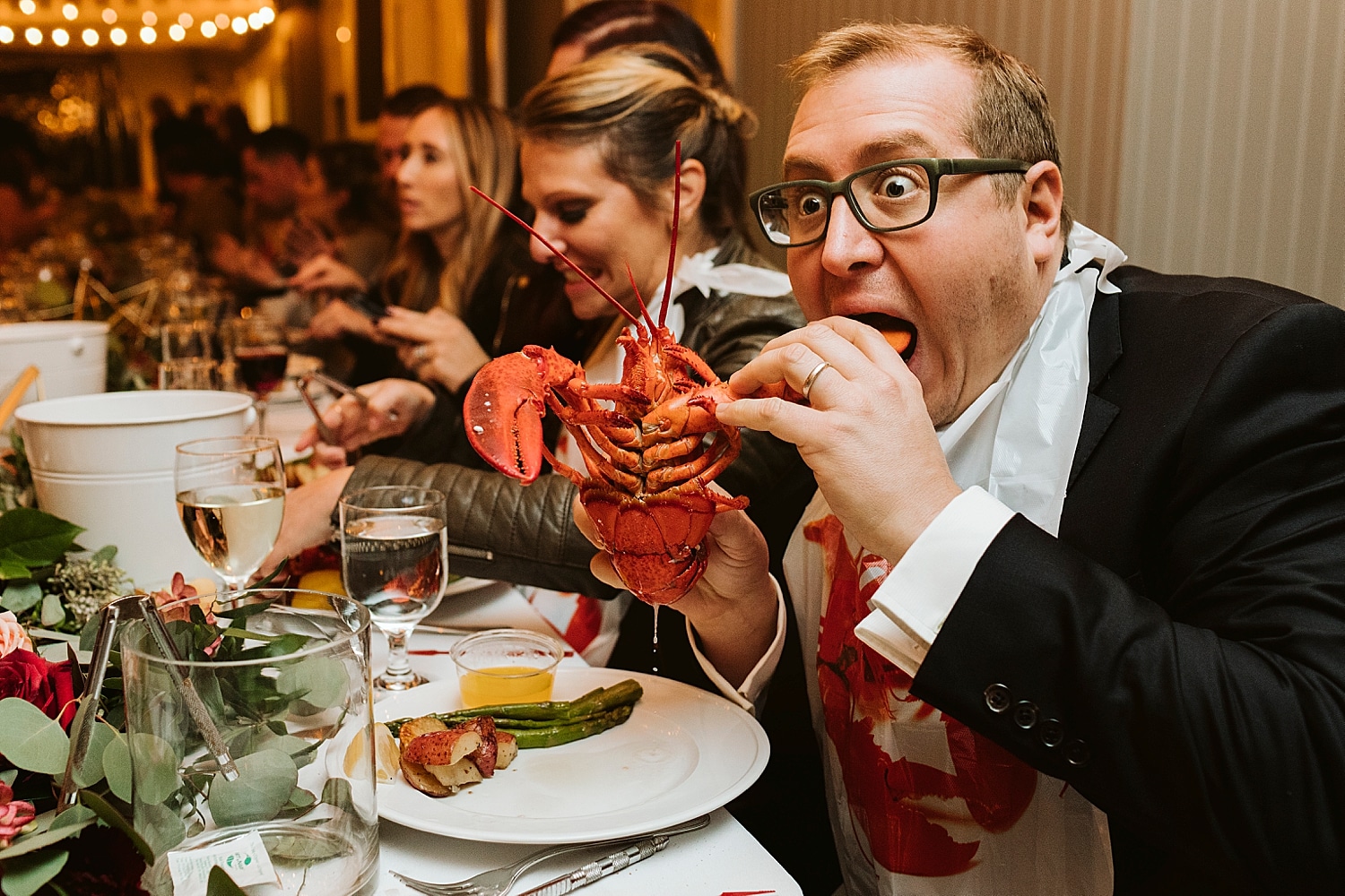 Maine wedding guest eating a lobster