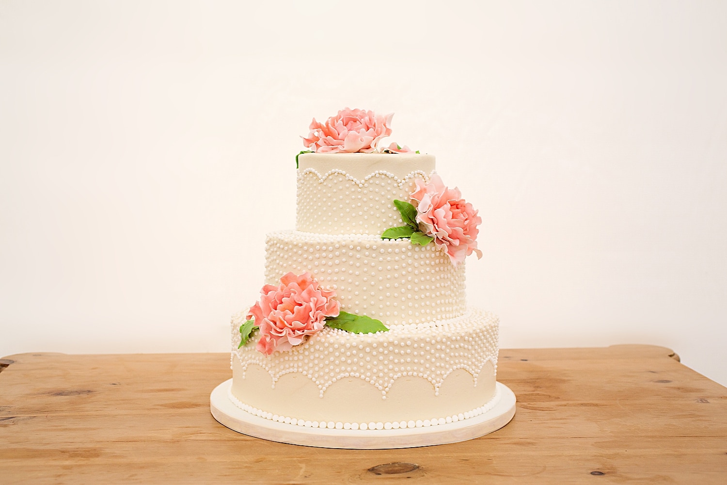 Pink, green and white wedding cake at Great Cranberry Island Maine wedding