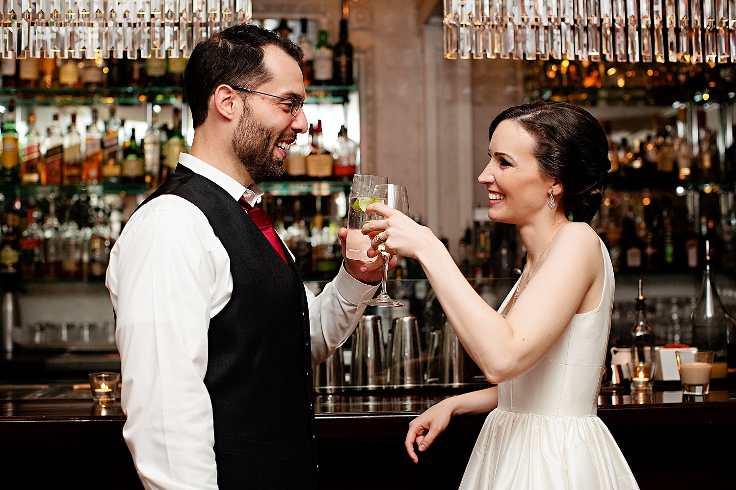 Bride and groom toast at bar at Maine wedding at the Camden Harbour Inn