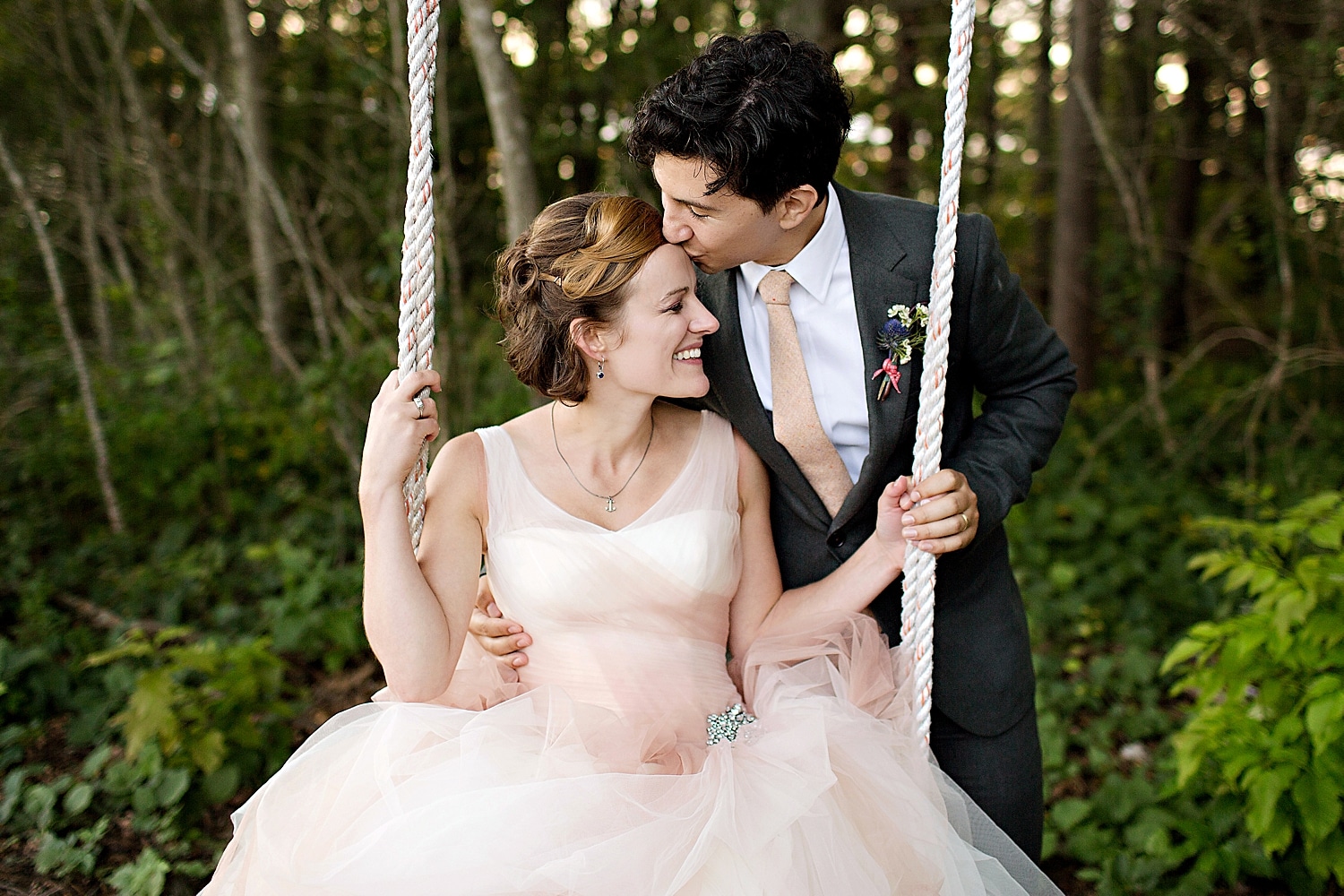 Bride and groom on swing at Marianmade Farm wedding in Wiscasset, Maine