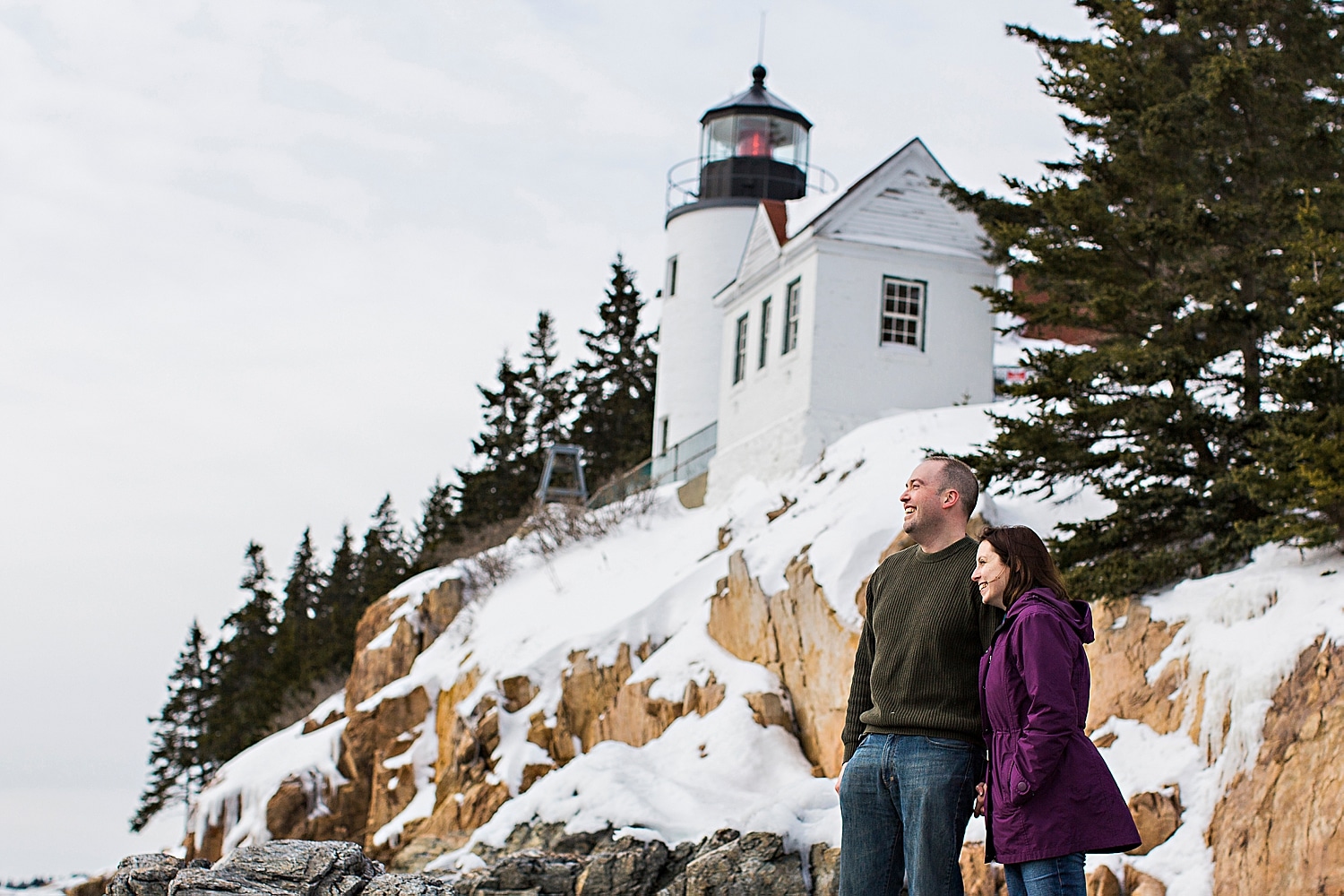 Portraits at Bass Harbor Light during winter engagement photos in Acadia National Park