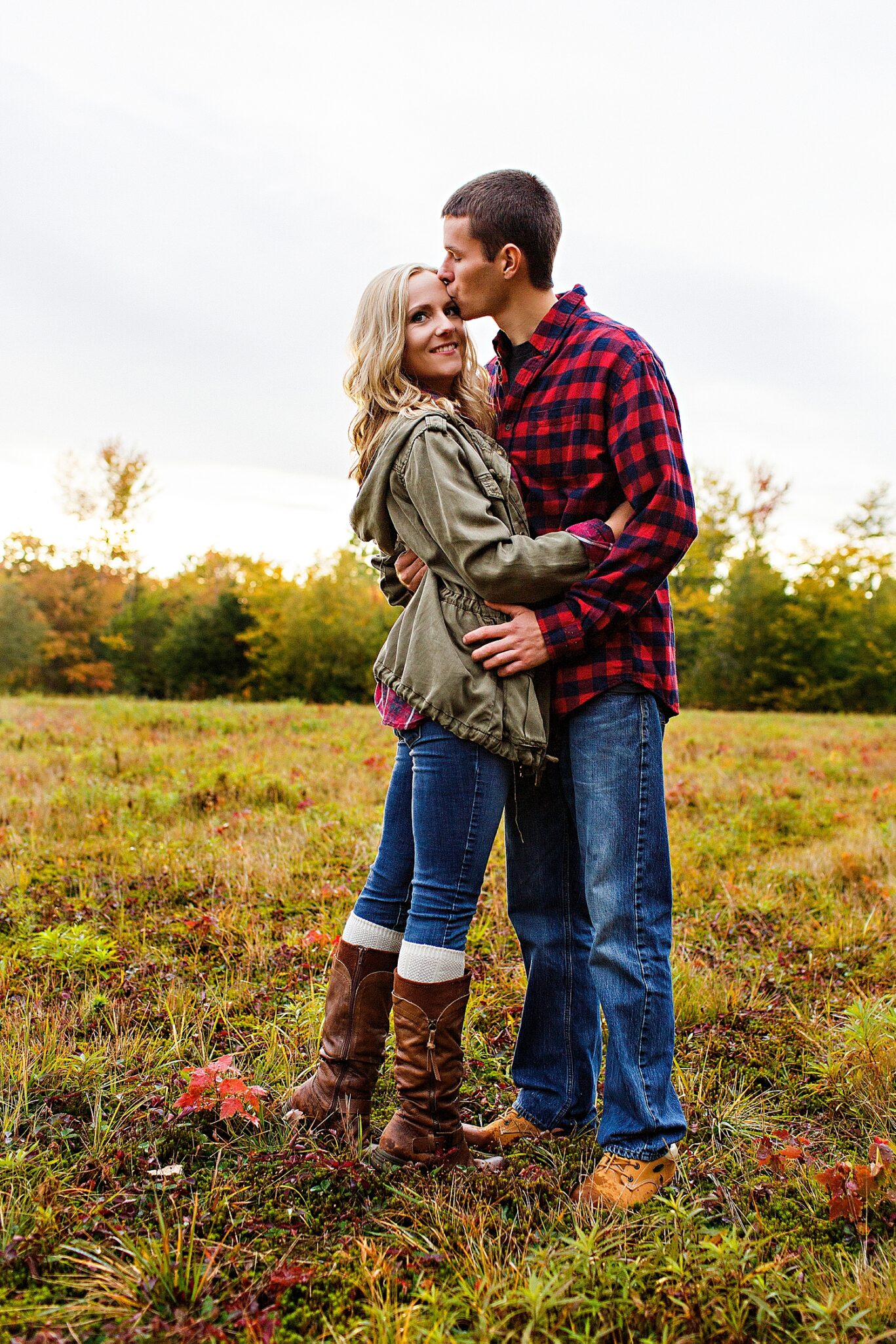 Max kissing Lauren's forehead during Fall engagement photos in Maine