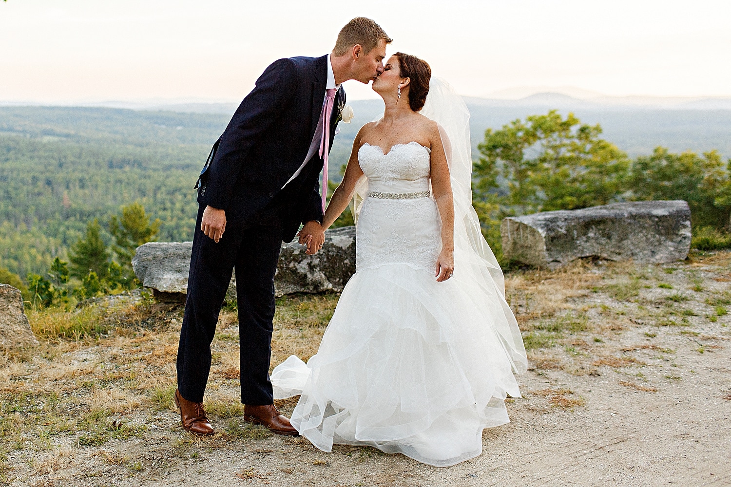 Bride and groom kiss at Maine wedding at Granite Ridge Estate & Barn