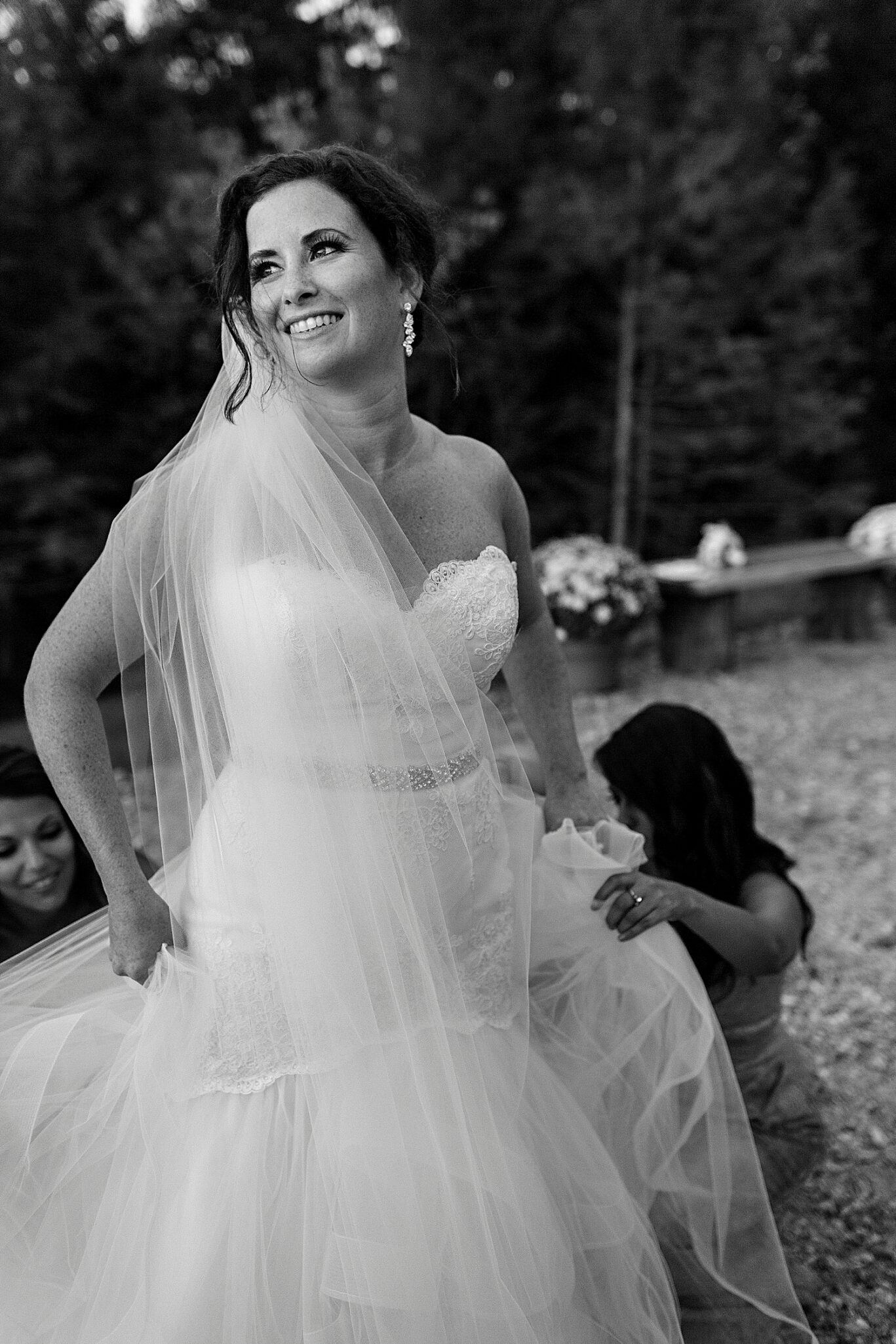 Bride's dress getting bustled at Maine wedding at Granite Ridge Estate & Barn
