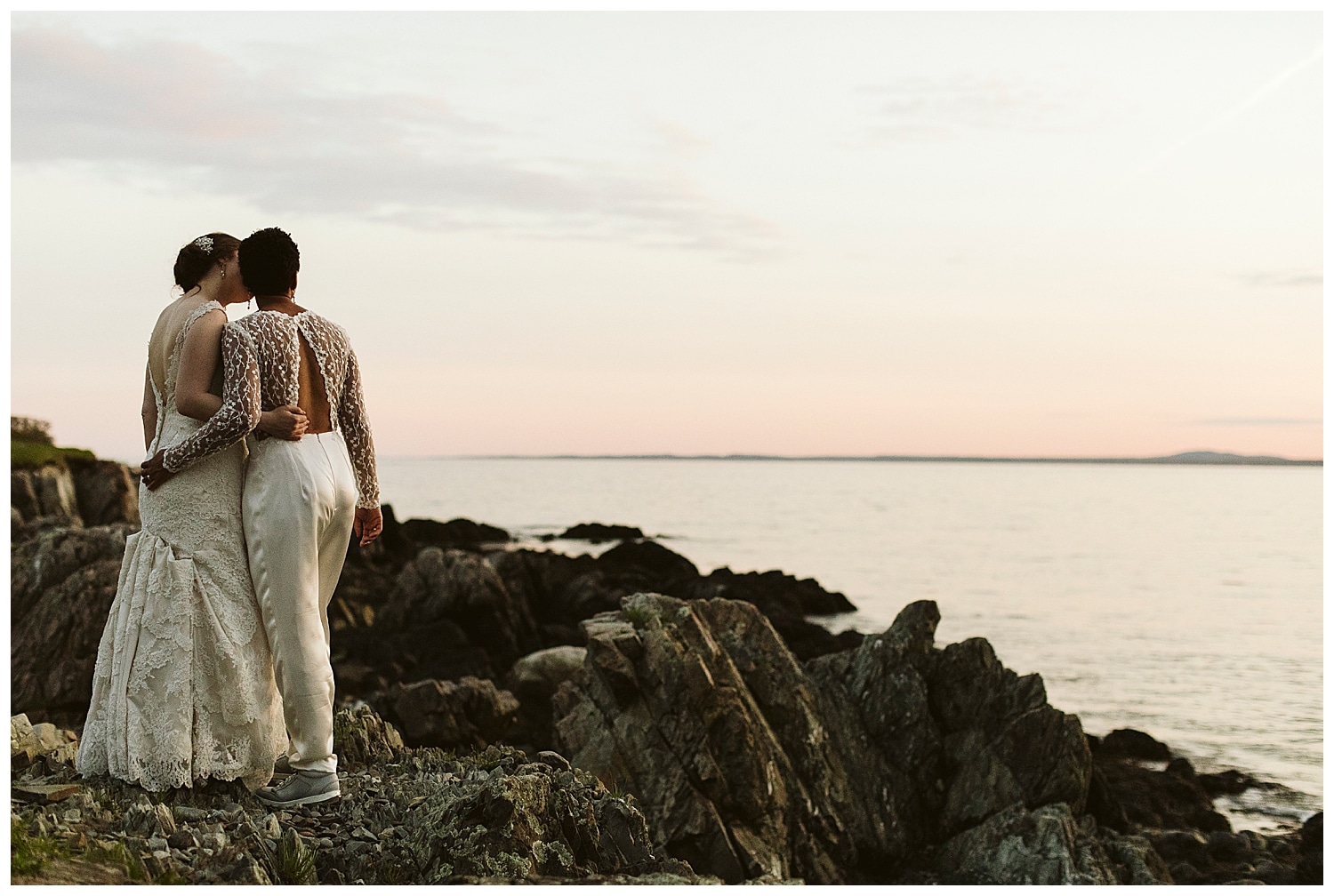 two brides on cliffs at sunset during Kennebunkport Maine wedding at The Colony Hotel