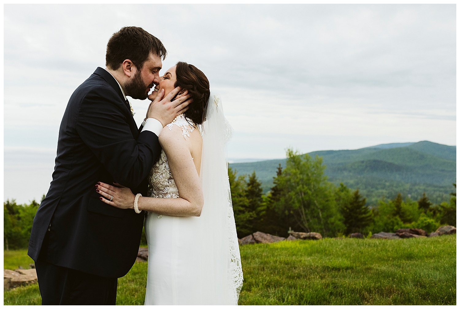 groom pulls bride in for a kiss at Northport Maine wedding