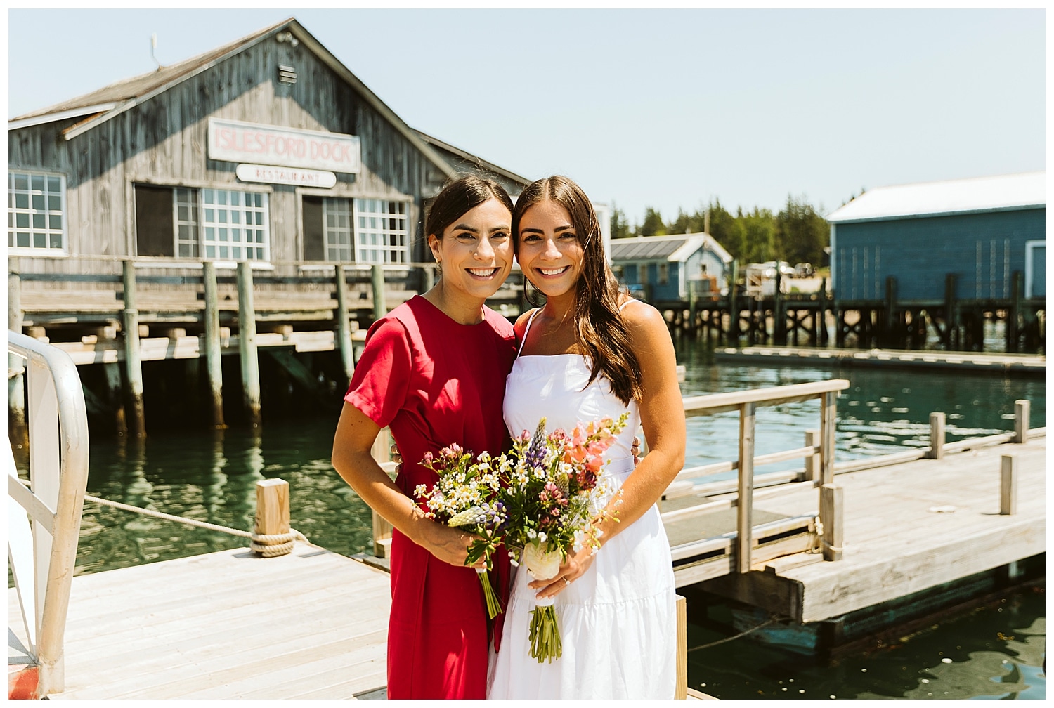 bride and maid of honor on dock on Isleford, Maine