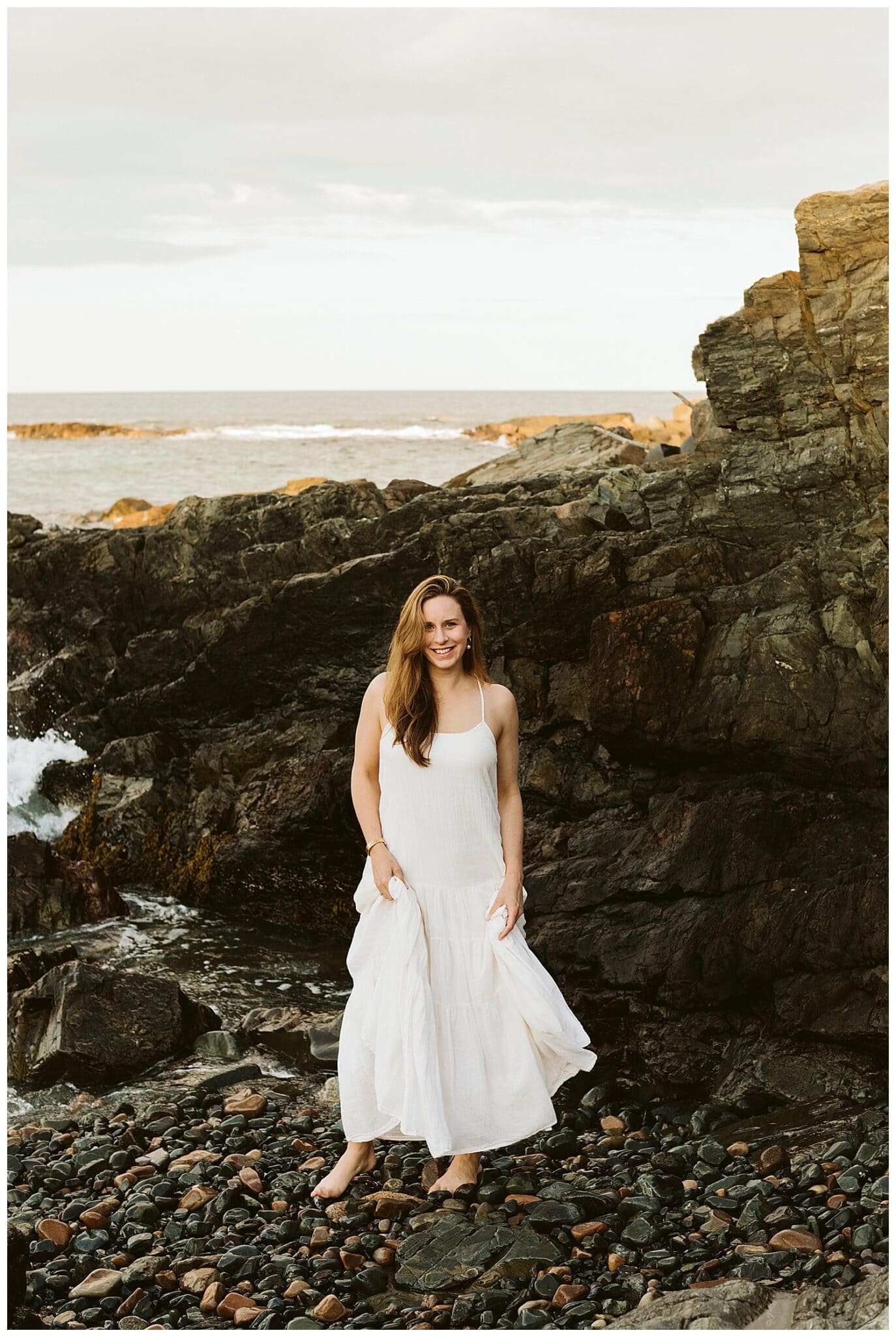 bride-to-be standing on rock during Ogunquit Maine engagement photos