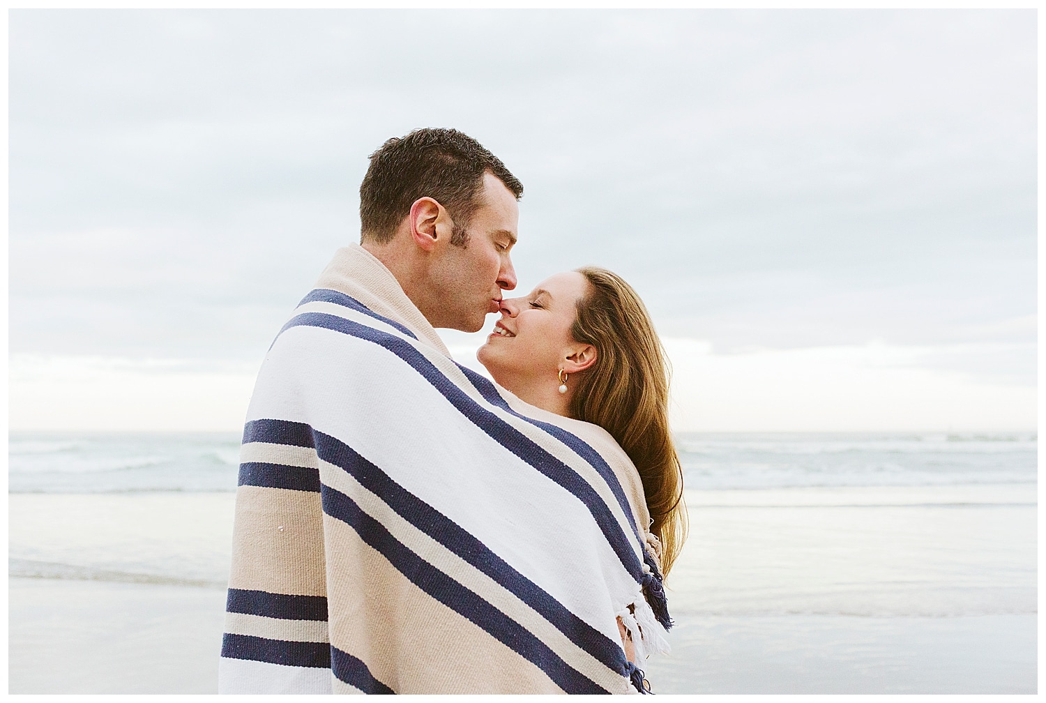 groom-to-be kissing bride-to-be's nose during Ogunquit Maine engagement photos