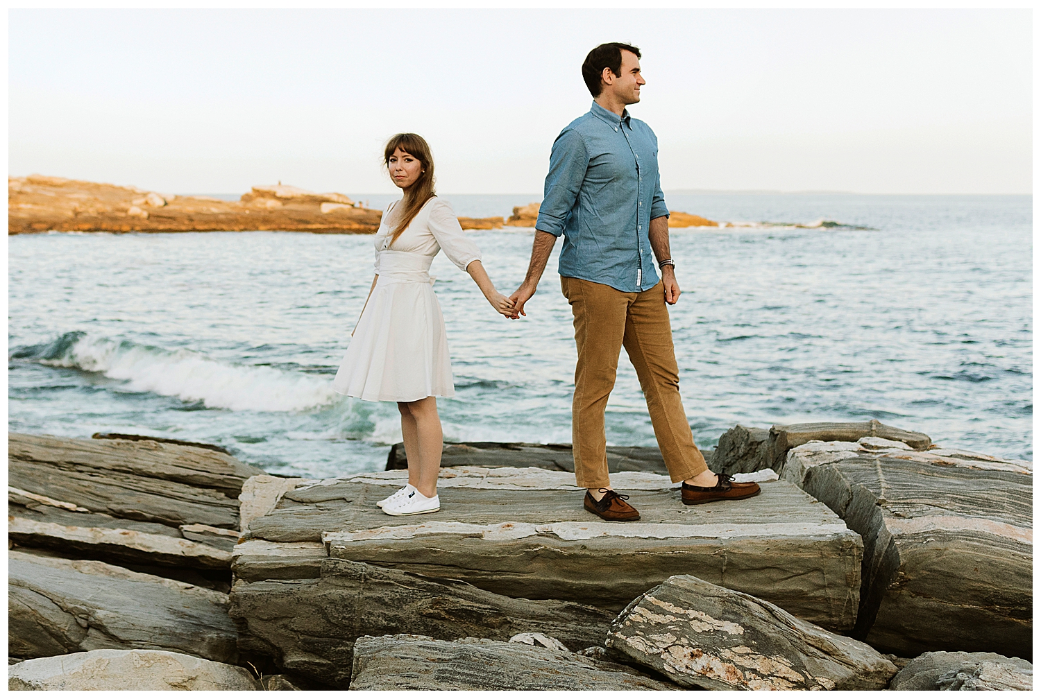 couple on the cliffs during Engagement photos in Bristol Maine