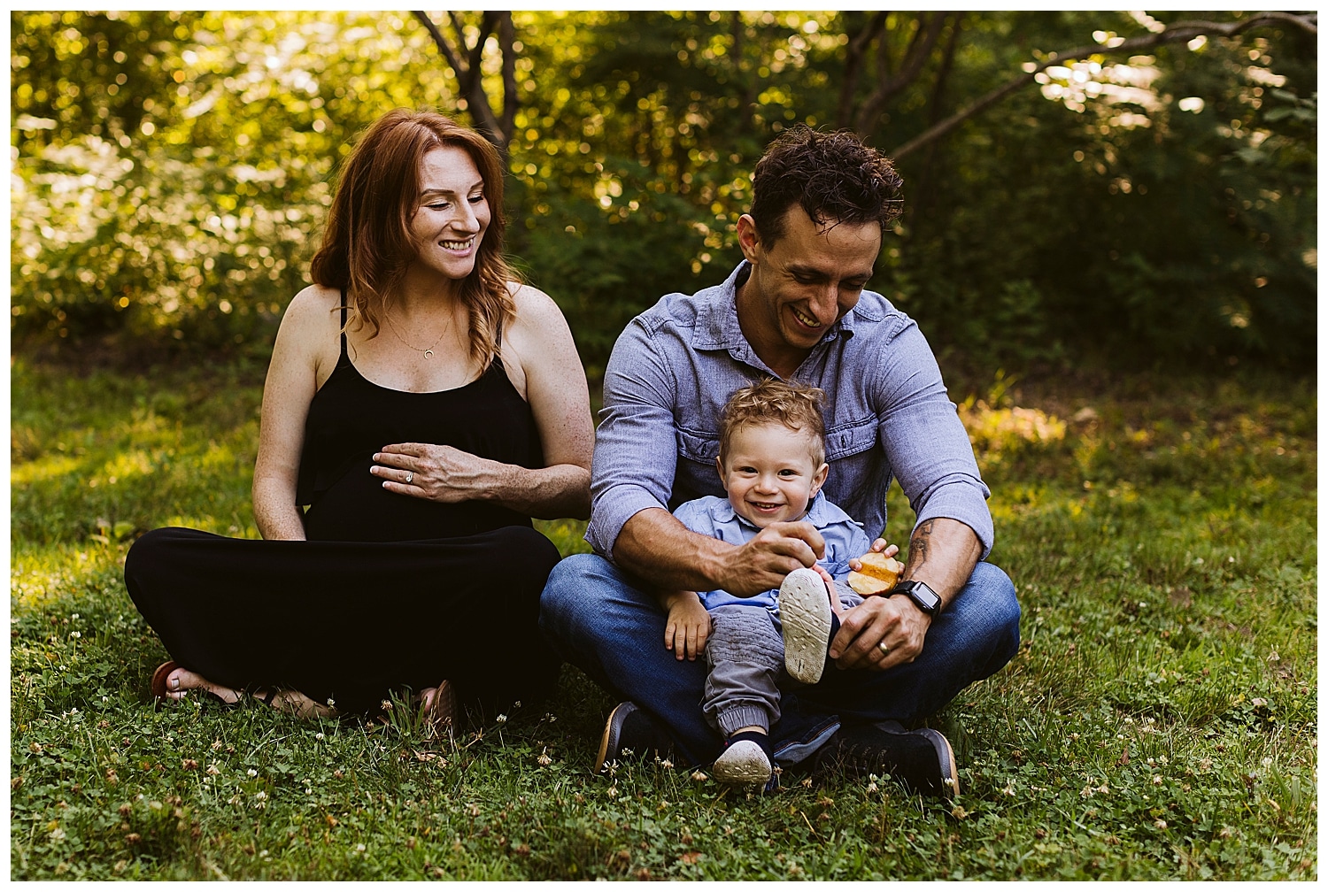 family laughing together during maternity photos at University of Maine
