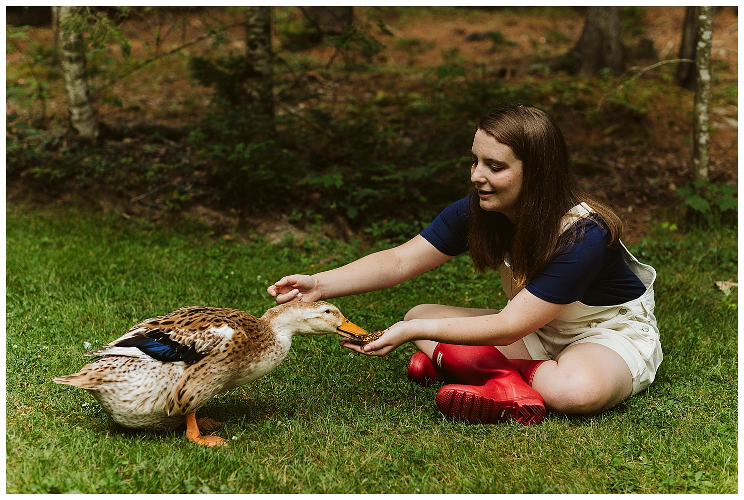 senior girl feeding pet duck