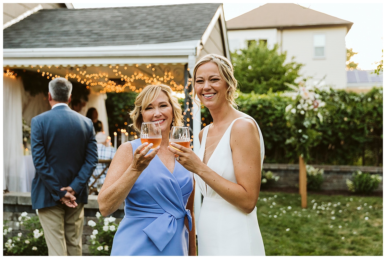 bride and mom clink glasses