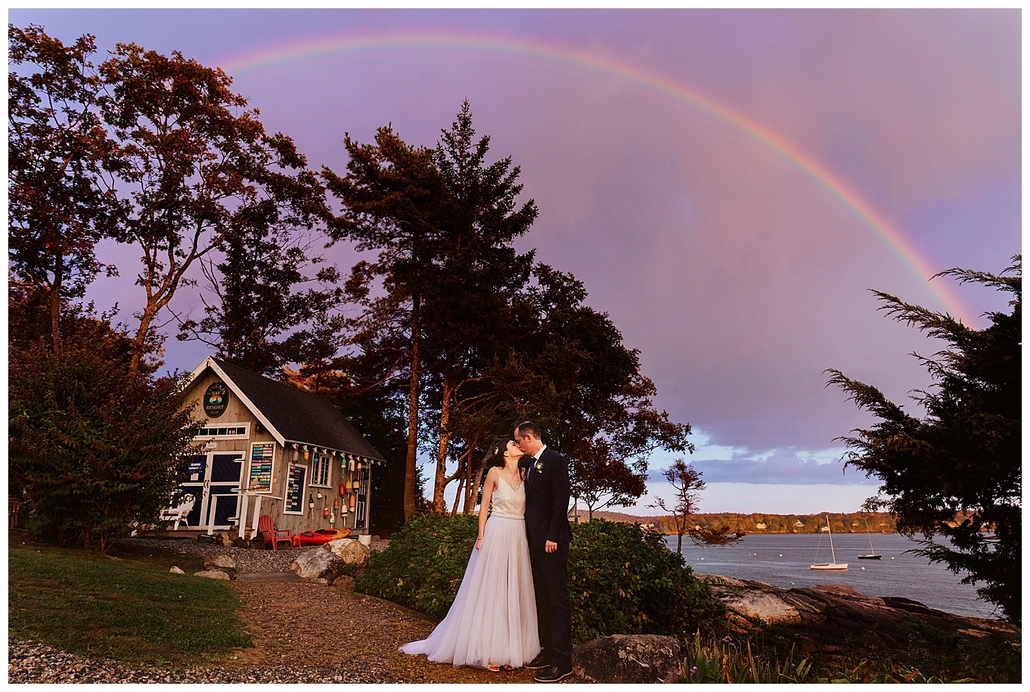bride and groom in front of rainbow during Boothbay Harbor, Maine wedding at Linekin Bay Resort