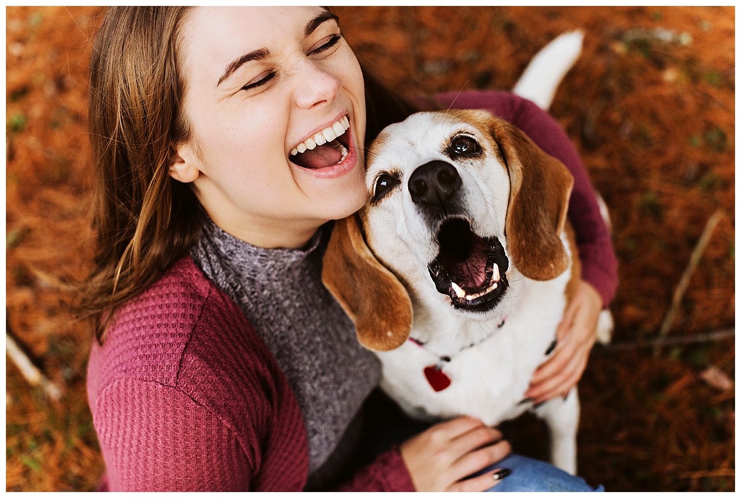 woman laughing with her dog