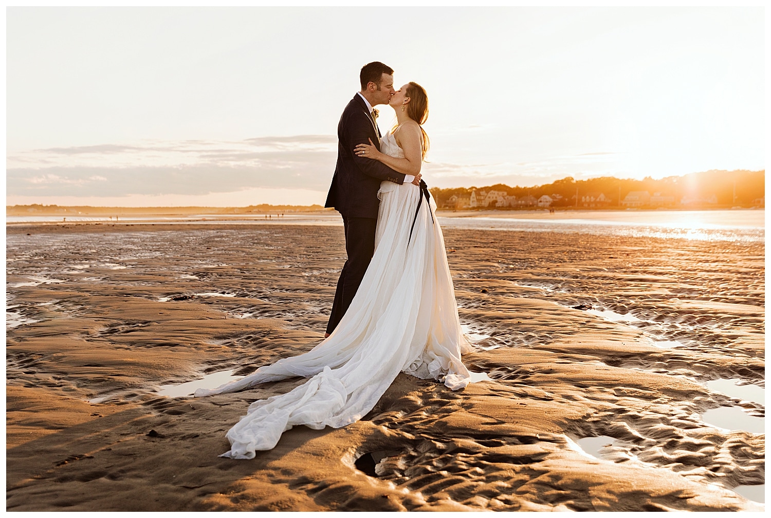 bride and groom kissing on Goose Rocks Beach