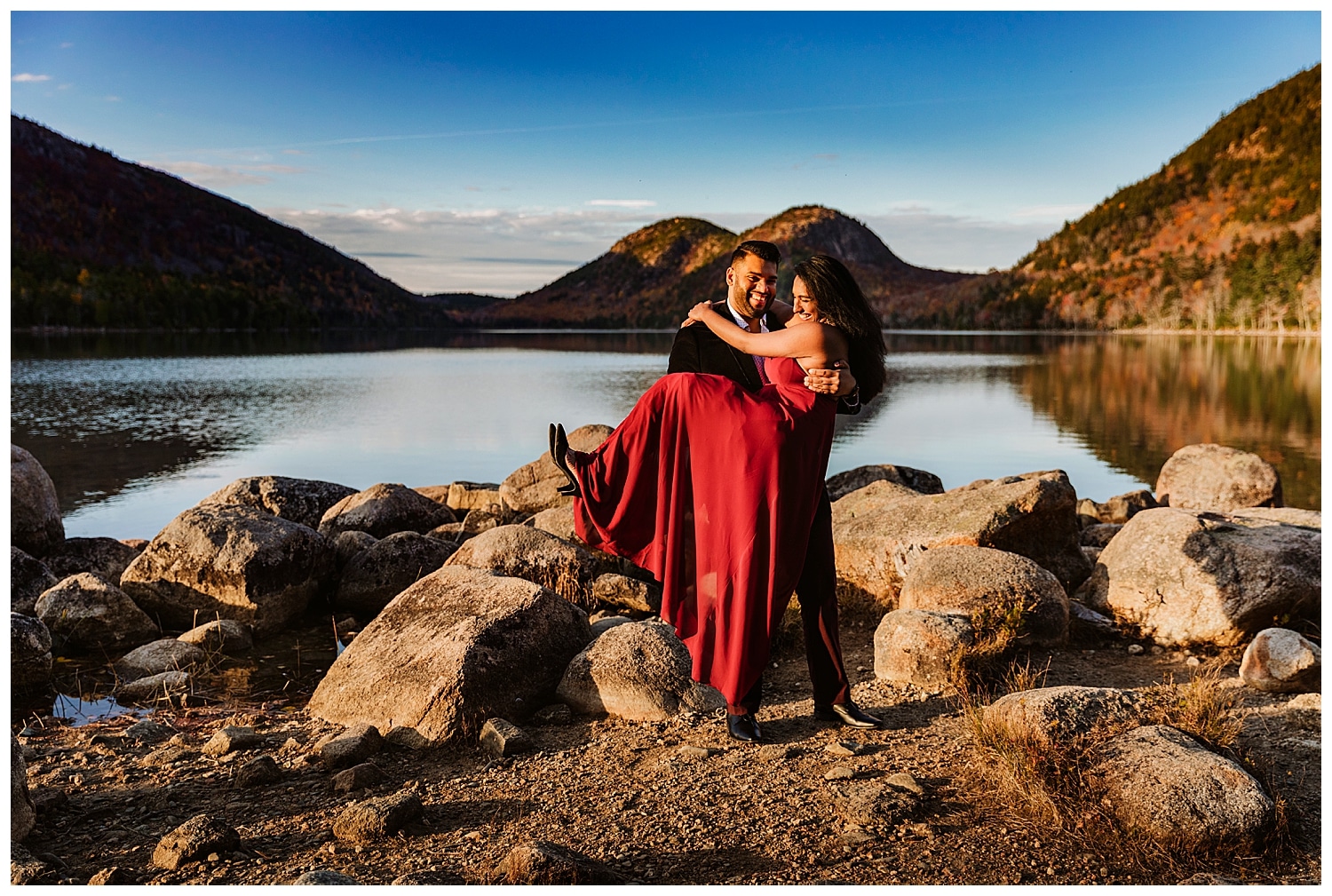 man carrying fiancee at Jordan Pond during Otter Point Acadia Engagement Photos