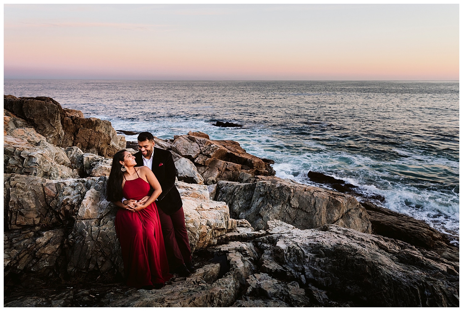 couple at sunset at Otter Point in Acadia National Park