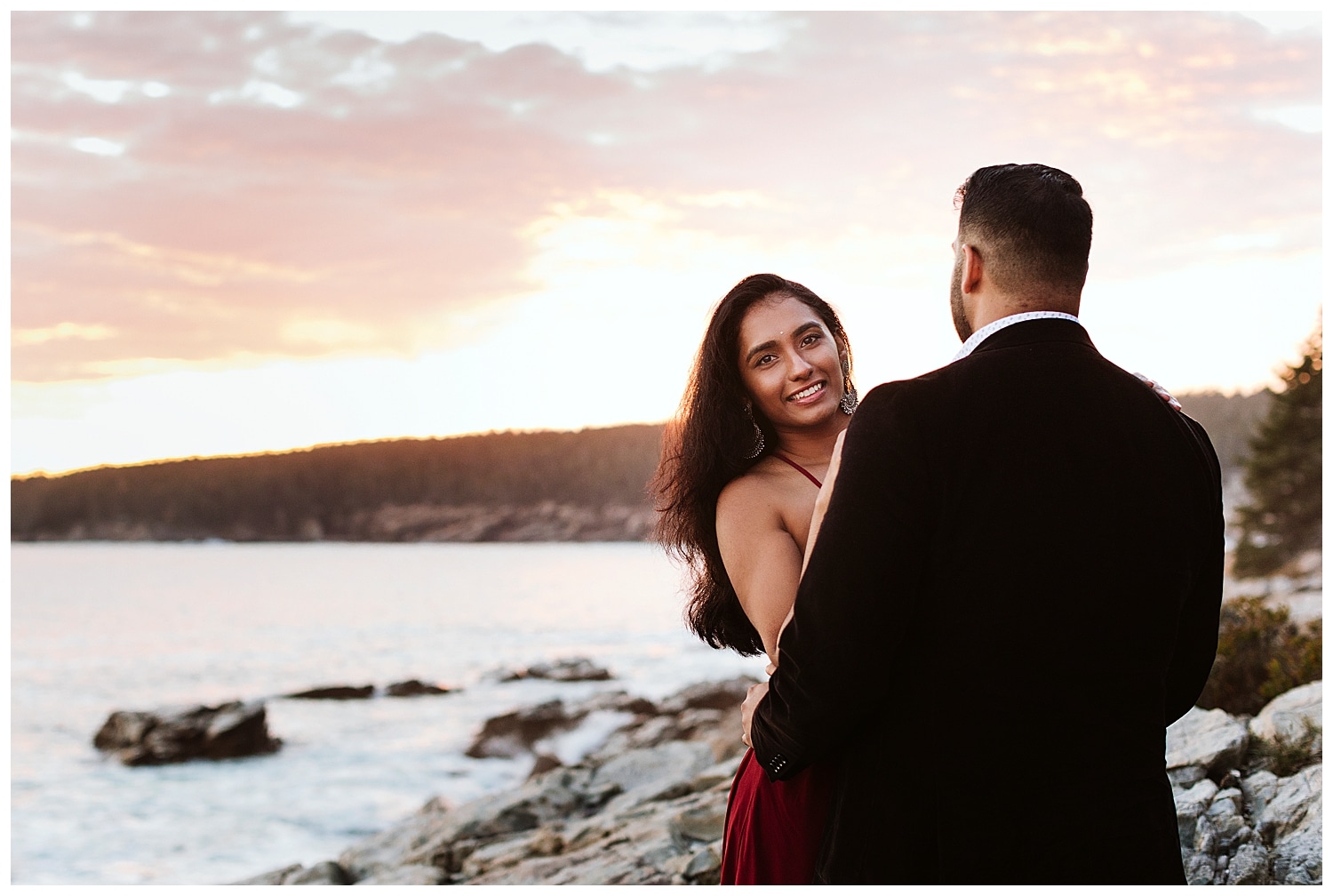 engaged couple at sunset at Otter Point in Acadia National Park